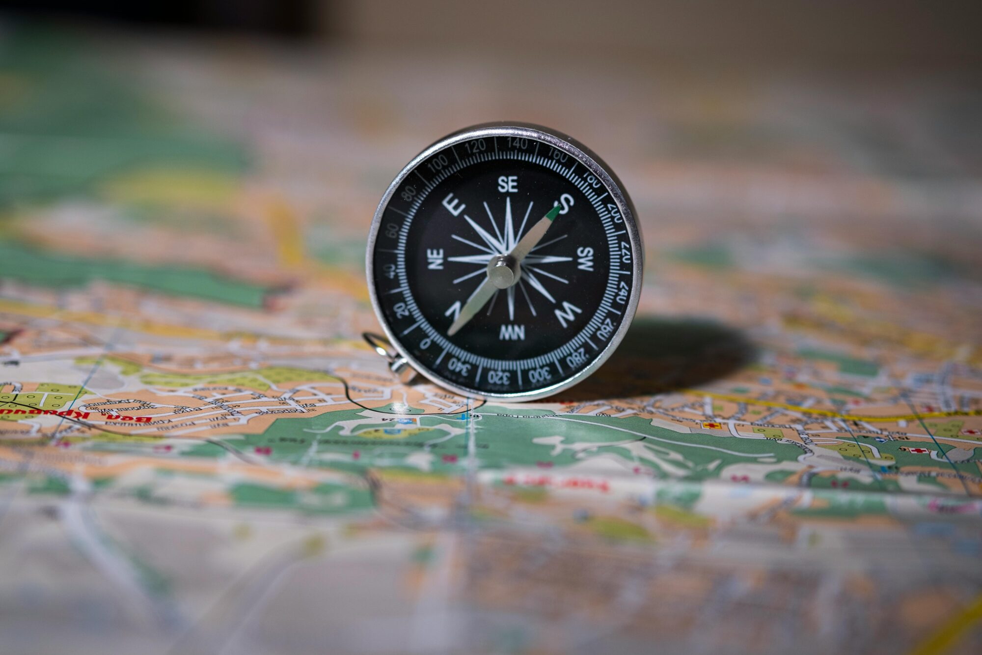 A compass resting on a detailed map, symbolising the importance of measuring the right things and finding your direction