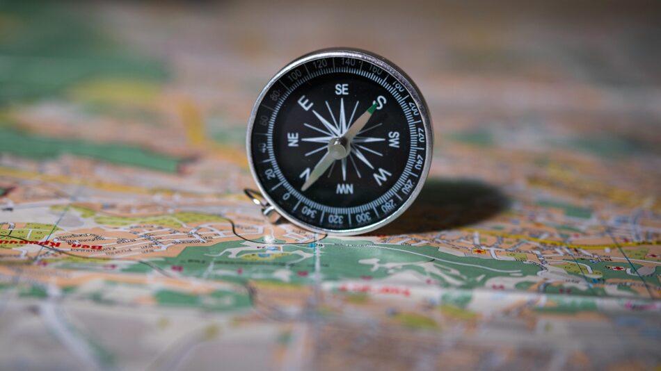 A compass resting on a detailed map, symbolising the importance of measuring the right things and finding your direction